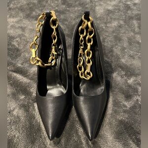 Black stilettos with gold ankle chain